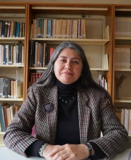 woman sitting in front of a library shelf